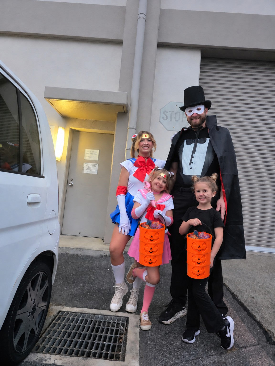 Family with extended trick-or-treat buckets