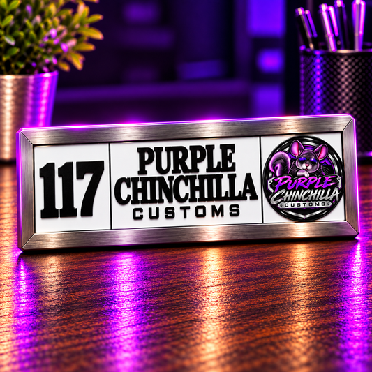 Custom 117 Room ID plaque with Purple Chinchilla Customs emblem on a purple-lit wooden desk