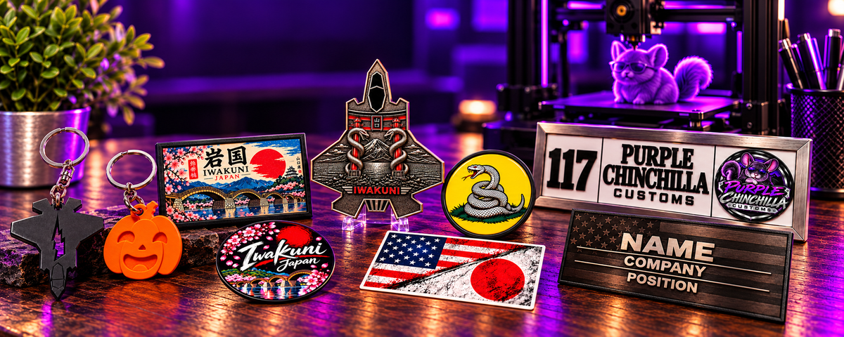 Purple Chinchilla Customs hero banner featuring keychains, magnets, stickers, challenge coin, plaques and signs, and 3D printing on the purple-lit wooden desk
